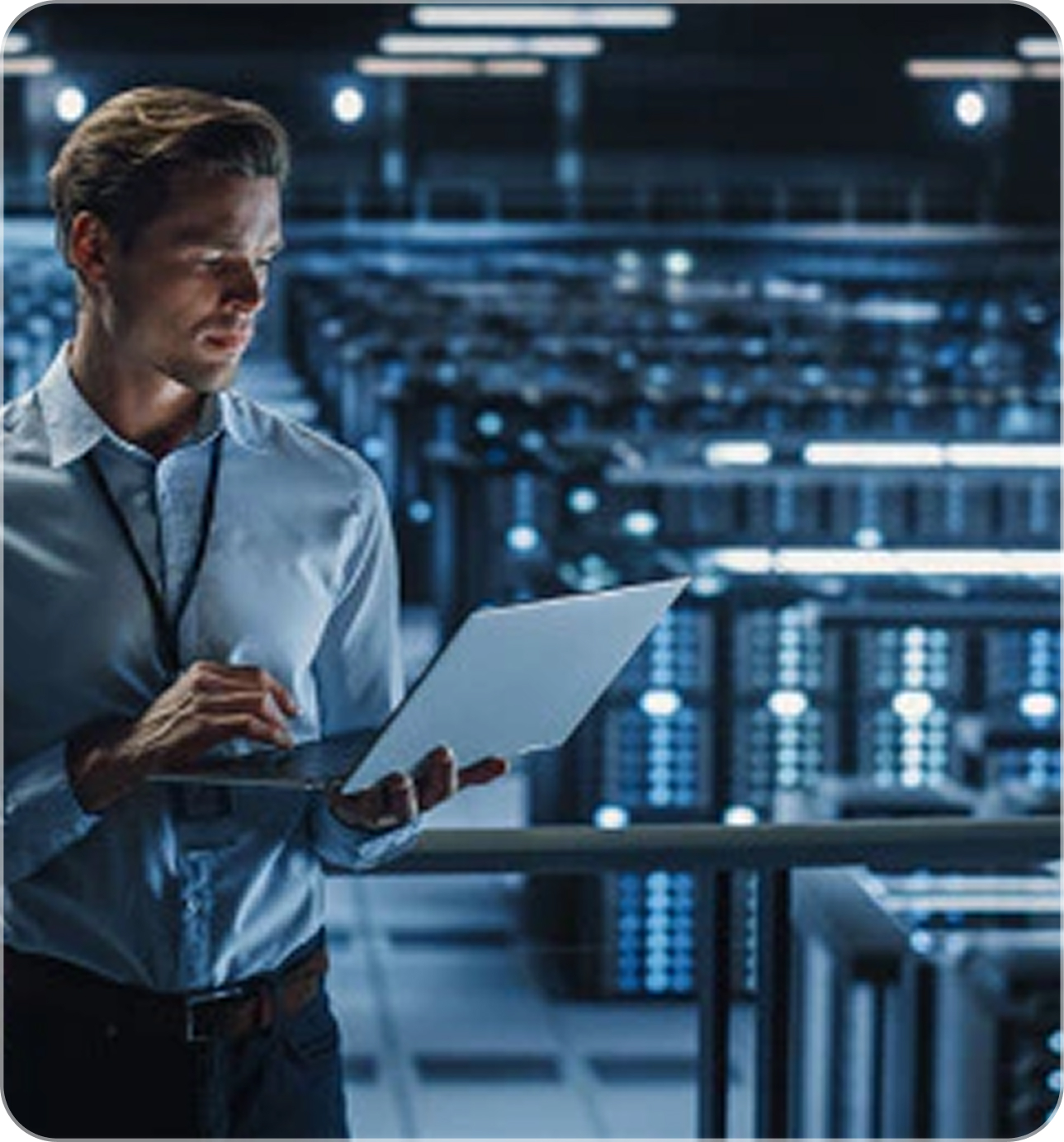 Person in server room with laptop